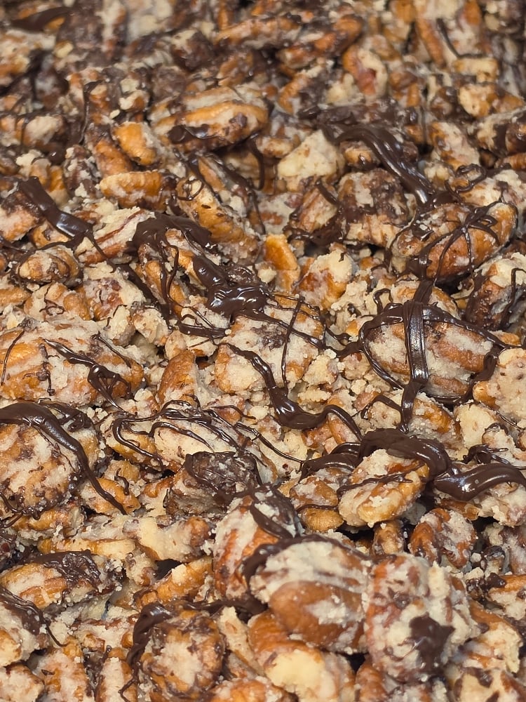 Chocolate drizzled cheesecake pecans